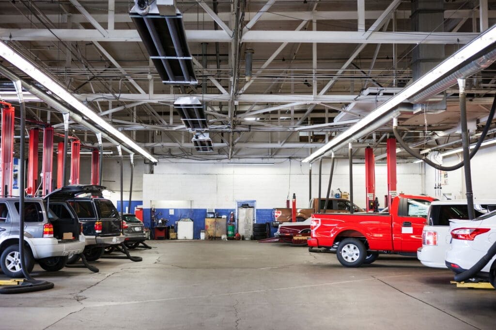 Rows of cars and trucks in auto repair shop